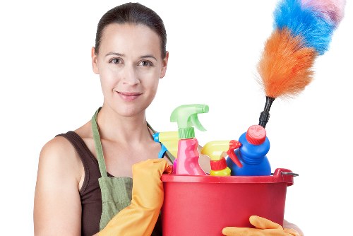 Professional cleaners scrubbing a kitchen floor during end of tenancy cleaning